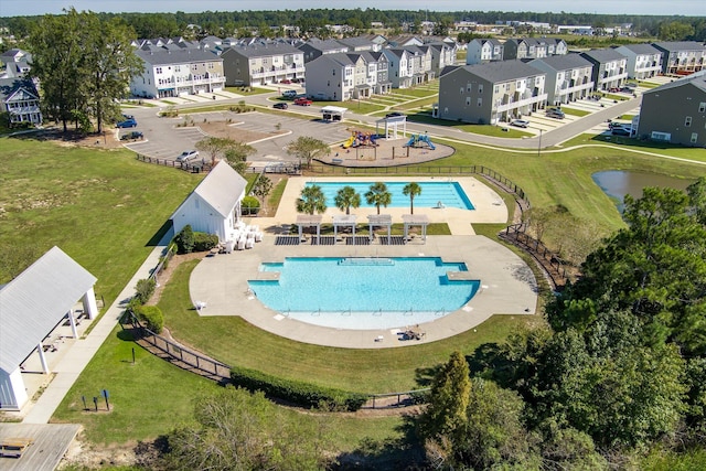 view of pool featuring a patio area and a yard