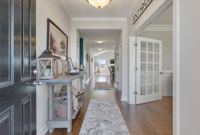 foyer featuring ornamental molding and dark wood-type flooring