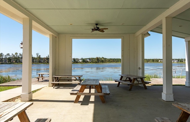 view of patio / terrace with a water view and ceiling fan