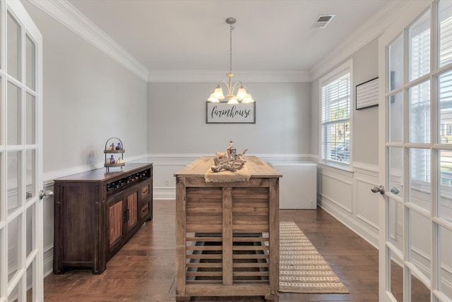 dining room featuring ornamental molding, french doors, a notable chandelier, and dark hardwood / wood-style flooring