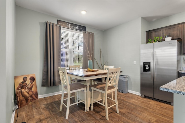 dining area featuring wood finished floors and baseboards