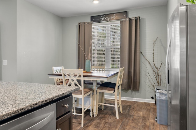 dining room featuring baseboards and dark wood-style flooring