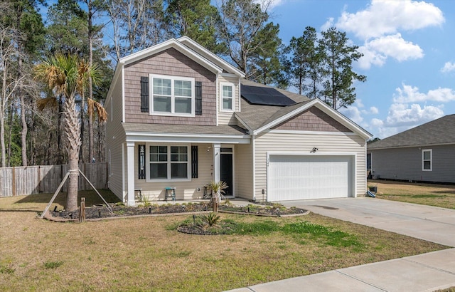 view of front of house with driveway, a front lawn, roof mounted solar panels, fence, and a garage