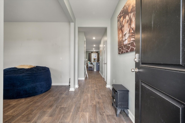 hall with baseboards and wood finished floors