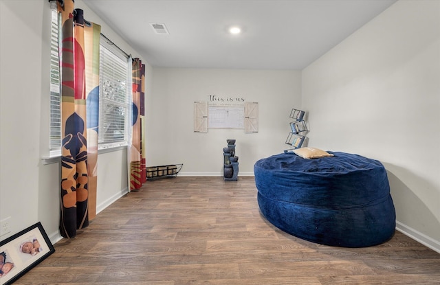 interior space featuring wood finished floors, visible vents, and baseboards