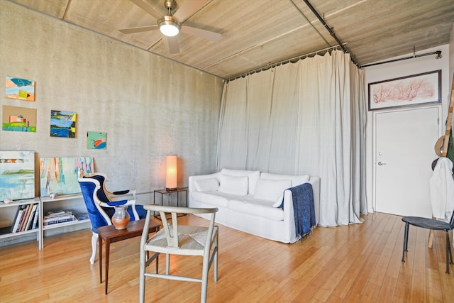 interior space with wood-type flooring and ceiling fan