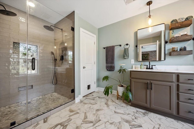 full bathroom with visible vents, baseboards, vanity, and a shower stall