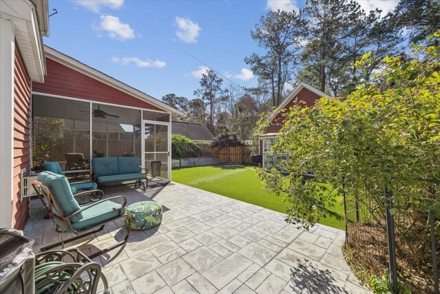 view of patio / terrace with an outdoor hangout area, a fenced backyard, and a sunroom