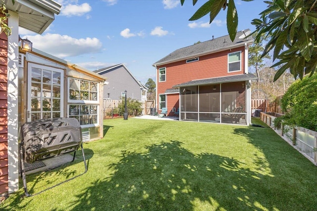 back of house with a yard, a fenced backyard, and a sunroom