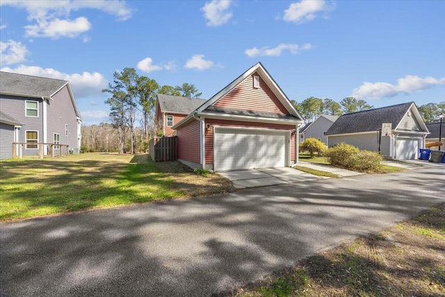 view of side of home with a lawn and driveway