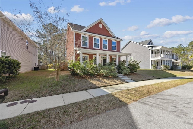 view of front of home with a front lawn and brick siding