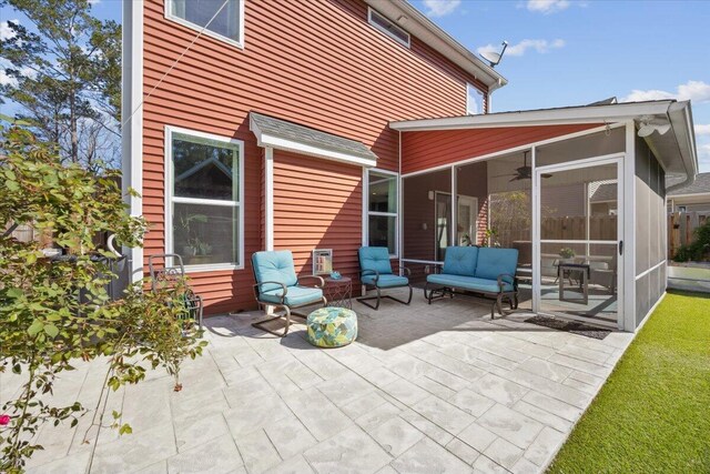 view of patio / terrace featuring outdoor lounge area and a sunroom