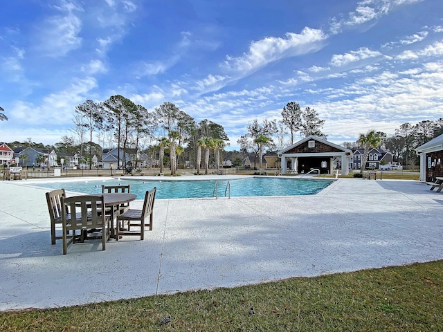 pool with a gazebo and a patio