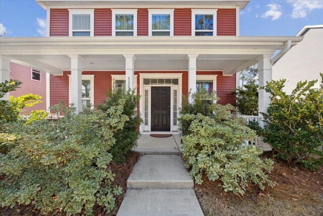 view of exterior entry featuring a porch