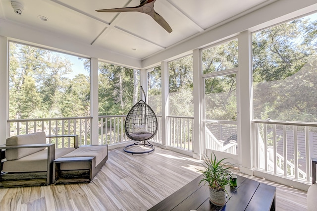 sunroom / solarium with coffered ceiling and ceiling fan