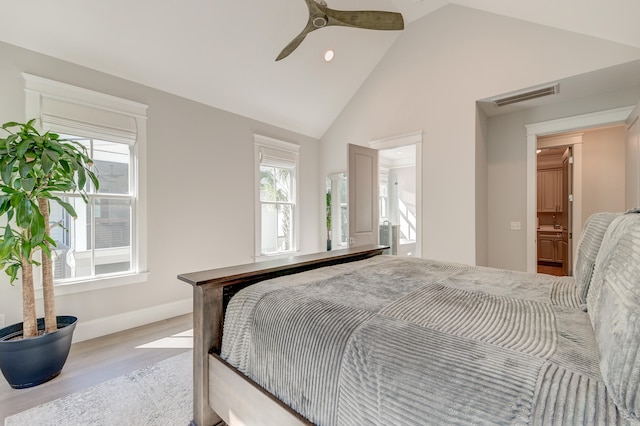 bedroom with ceiling fan, high vaulted ceiling, and light hardwood / wood-style flooring