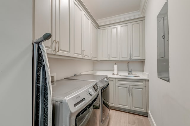 clothes washing area featuring sink, cabinets, electric panel, independent washer and dryer, and light hardwood / wood-style floors