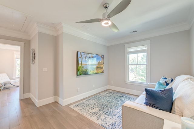 living area featuring ornamental molding, ceiling fan, and light wood-type flooring