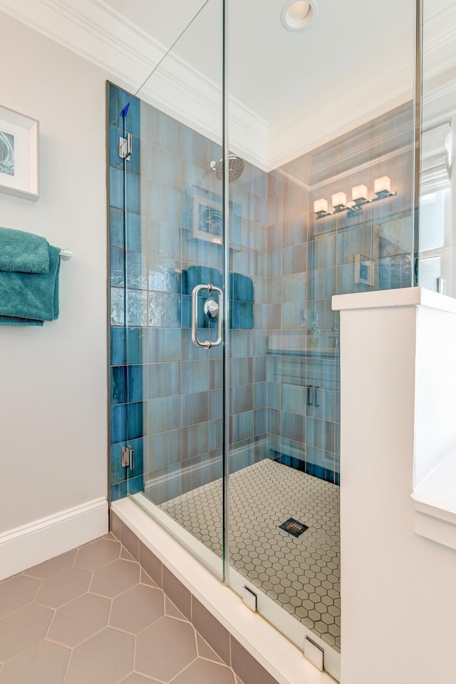 bathroom with crown molding, tile patterned floors, and a shower with shower door