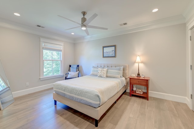 bedroom featuring crown molding, ceiling fan, and light wood-type flooring