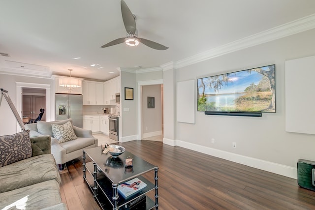 living room with ornamental molding, dark hardwood / wood-style floors, and ceiling fan with notable chandelier