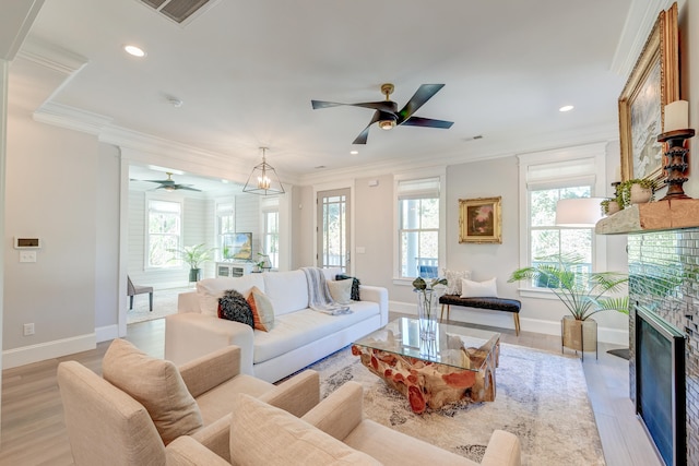 living room featuring crown molding, ceiling fan, and light hardwood / wood-style floors