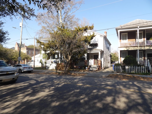 view of front of house featuring a porch and fence