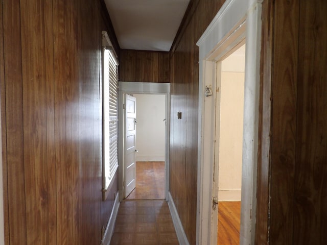 hall with wooden walls and parquet flooring