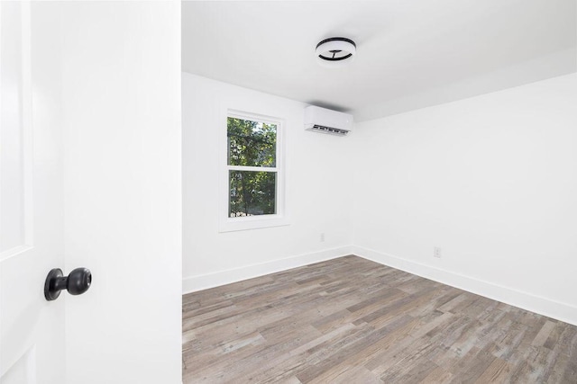 2924 Chicora Ave, North Charleston, SC 29405 - empty room featuring a wall unit AC and wood finished floors