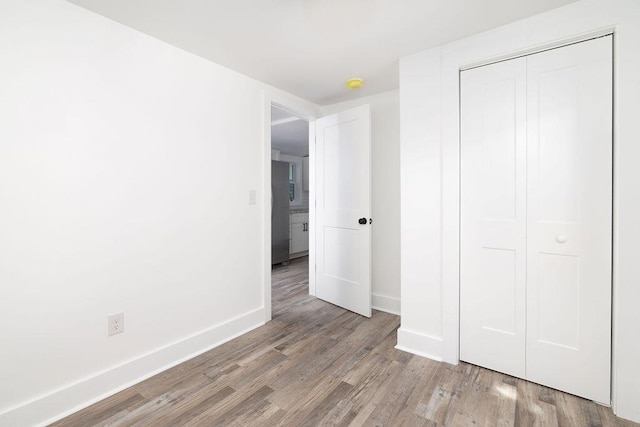 2924 Chicora Ave, North Charleston, SC 29405 - unfurnished bedroom with wood finished floors, a closet, and stainless steel refrigerator