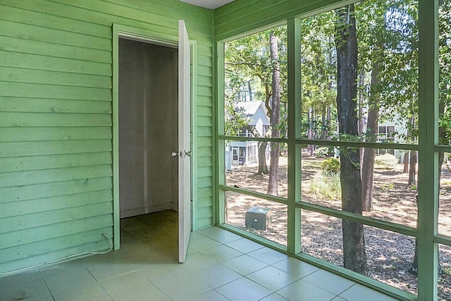 doorway with wood walls