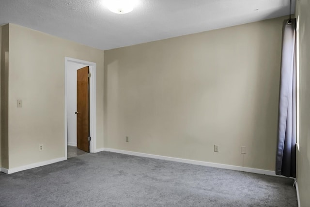 empty room featuring dark colored carpet