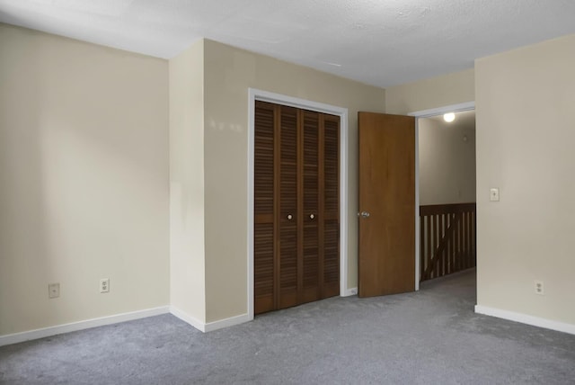 unfurnished bedroom featuring carpet and a closet