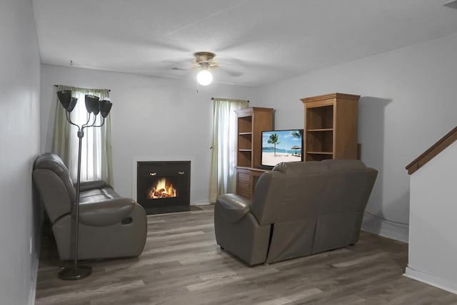 living room with ceiling fan and wood-type flooring