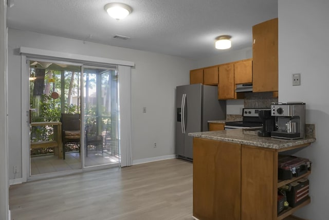 kitchen featuring stainless steel fridge, tasteful backsplash, a textured ceiling, electric range, and light hardwood / wood-style flooring