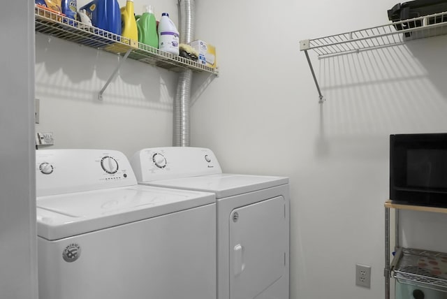 washroom featuring washer and dryer