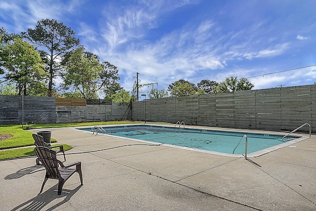 view of swimming pool featuring a patio