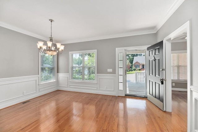 interior space with crown molding, light hardwood / wood-style flooring, and a notable chandelier