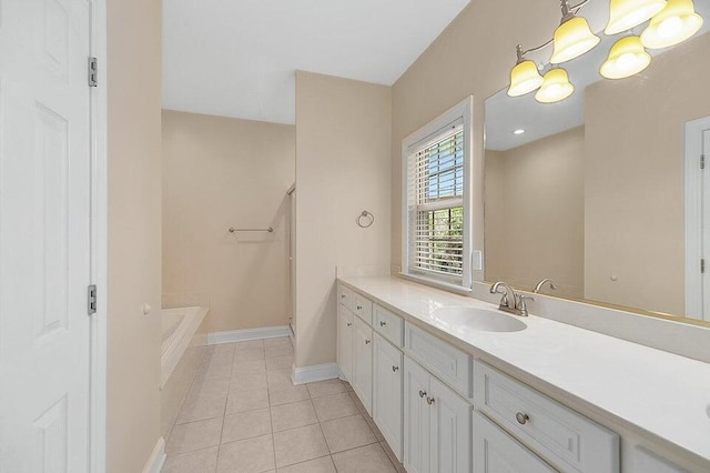 bathroom featuring vanity, a bath, and tile patterned floors