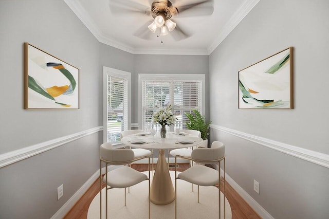 dining area featuring ornamental molding, ceiling fan, and light wood-type flooring