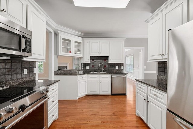 kitchen featuring stainless steel appliances and white cabinetry