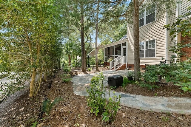 view of yard with a patio and a sunroom