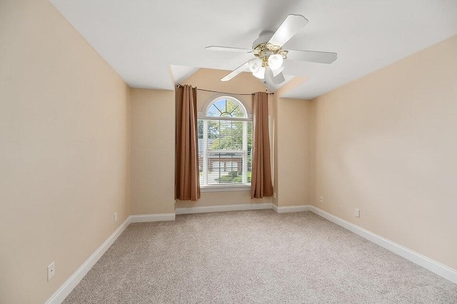 unfurnished room with vaulted ceiling, ceiling fan, and carpet floors