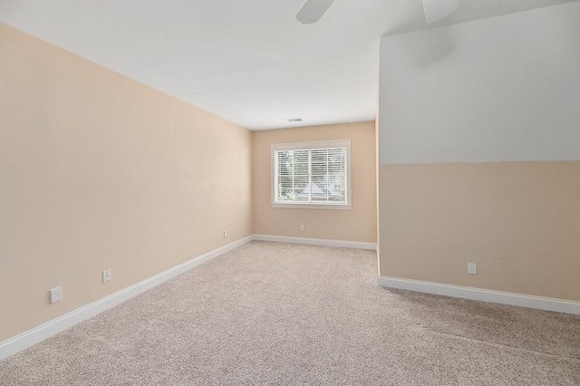 spare room with light colored carpet and ceiling fan