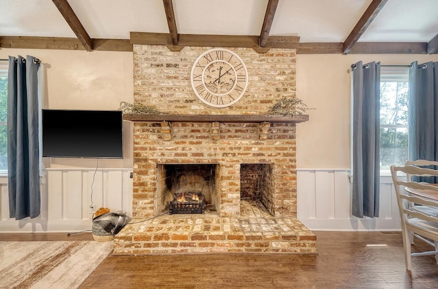 living room featuring a fireplace, beam ceiling, and dark hardwood / wood-style flooring