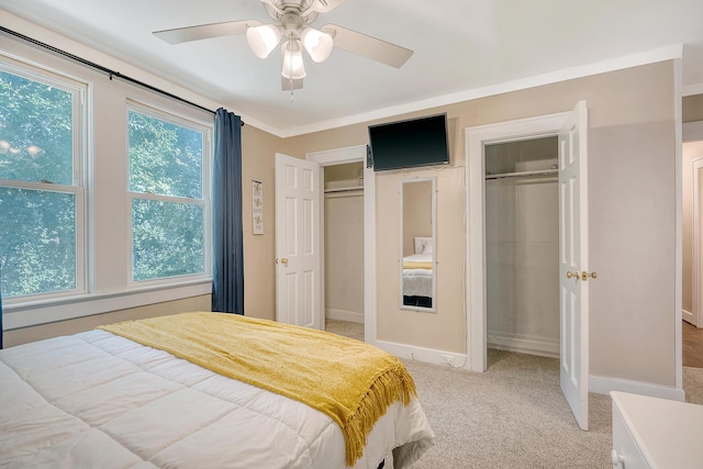 bedroom featuring ceiling fan, light carpet, and crown molding