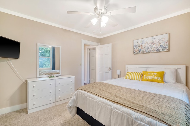 carpeted bedroom with ornamental molding and ceiling fan