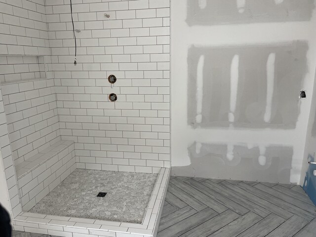 bathroom with tiled shower