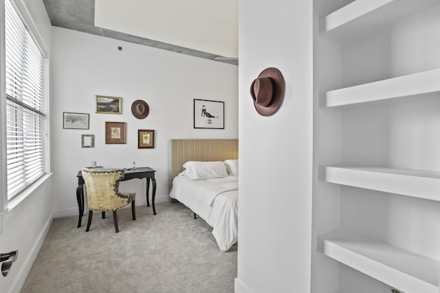 carpeted bedroom with baseboards