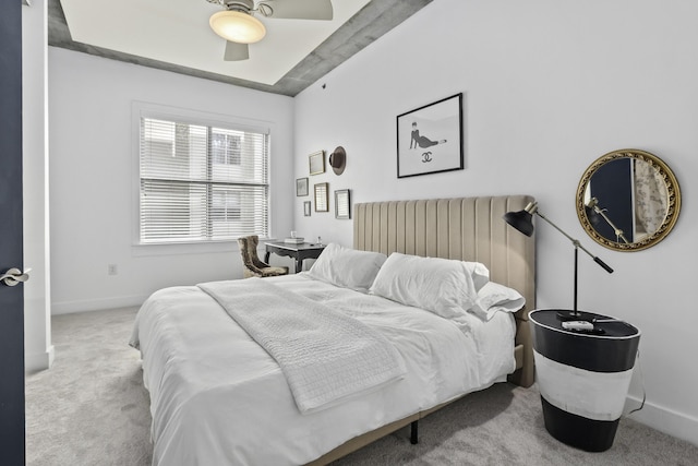 carpeted bedroom featuring a ceiling fan and baseboards